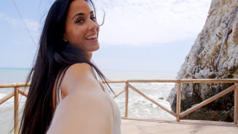 Brunette-Woman-Taking-Self-Portrait-by-Ocean