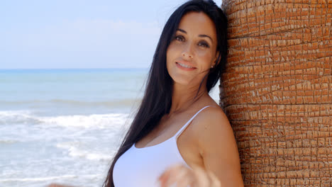 Thoughtful-Lady-Leaning-Against-Beach-Palm-Tree