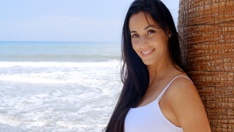 Woman-at-the-Beach-Leaning-Against-Tree-Trunk