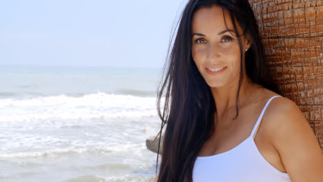 Woman-at-the-Beach-Leaning-Against-Tree-Trunk