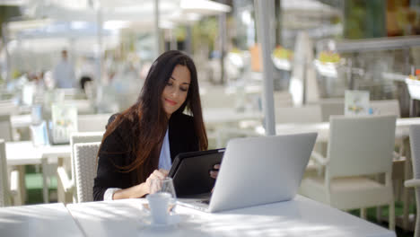 Businesswoman-making-a-call-at-a-restaurant