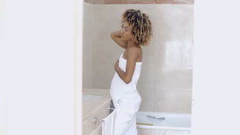 Woman-Looking-In-The-Mirror-In-Bathroom