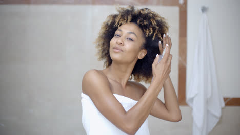 Woman-Using-Hair-Spray-In-Bathroom