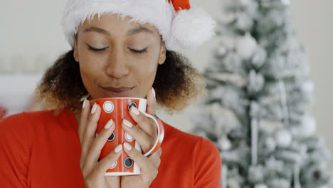 Young-woman-enjoying-hot-coffee-at-Christmas