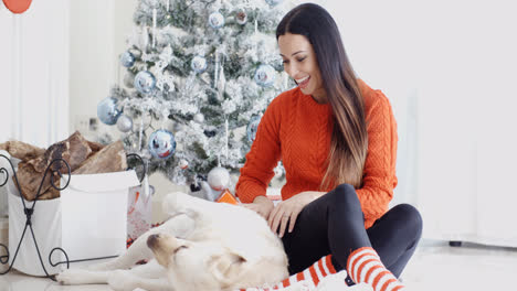 Young-woman-having-fun-with-her-golden-labrador