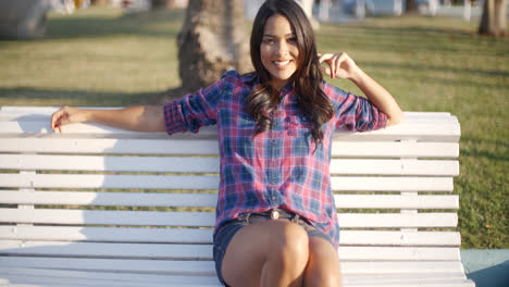 Girl-Relaxing-On-Bench-In-Park