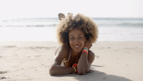 Woman-In-A-Swimsuit-Relaxing-On-The-Sand