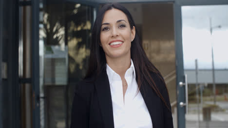 Young-businesswoman-exiting-a-modern-office