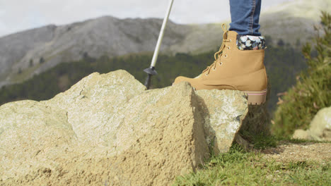 Person-in-hiking-boots-in-the-mountains