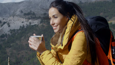 Young-woman-backpacker-enjoying-coffee