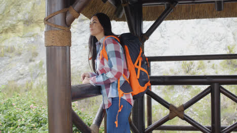 Smiling-backpacker-on-a-mountain-lookout