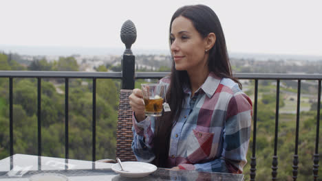 Young-woman-enjoying-a-hot-cup-of-tea