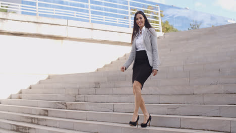 Smiling-woman-walking-down-staircase