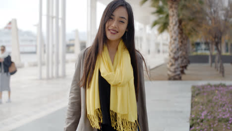 Stylish-young-woman-enjoying-a-walk-in-town