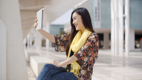 Woman-taking-a-self-portrait-with-tablet