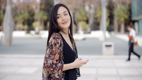 Young-woman-walking-listening-to-music