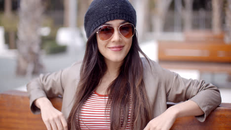 Happy-relaxed-trendy-woman-sitting-daydreaming