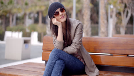 Happy-relaxed-trendy-woman-sitting-daydreaming