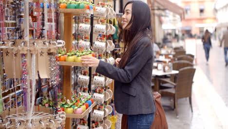 Smiling-young-woman-checking-out-shop-merchandise