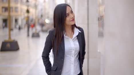 Attractive-young-woman-window-shopping-in-town