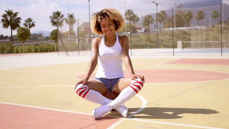 Bastante-Joven-Atleta-Femenina-Se-Sienta-En-Baloncesto