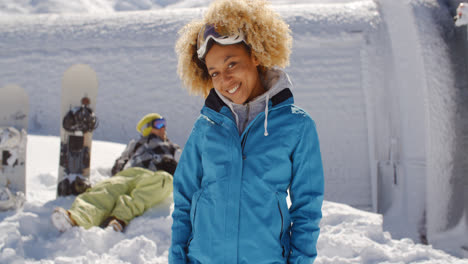 Cute-skier-in-front-of-friend-in-snow