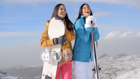 Two-young-woman-with-their-snowboards