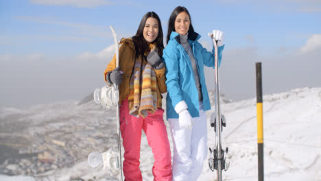 Two-young-woman-with-their-snowboards