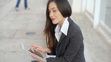 Calm-professional-woman-using-tablet