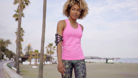 Low-angle-view-of-woman-walking-along-beach