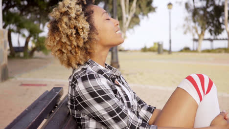 Contented-woman-with-eyes-closed-at-park