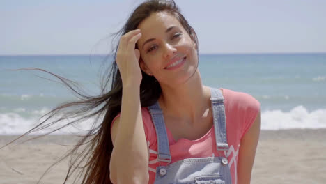 Woman-with-hand-near-hair-blowing-in-the-wind