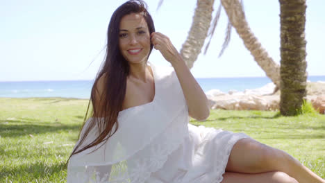 Gorgeous-lady-sitting-among-palm-trees