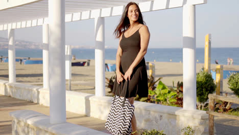 Attractive-woman-waiting-on-a-seafront-promenade