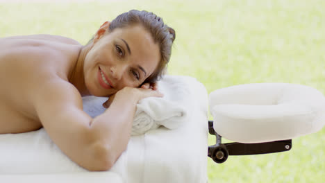 Woman-smiles-at-camera-while-at-spa