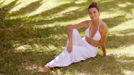 Smiling-friendly-young-woman-relaxing-in-a-garden