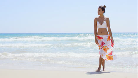 Sexy-young-woman-walking-through-the-surf