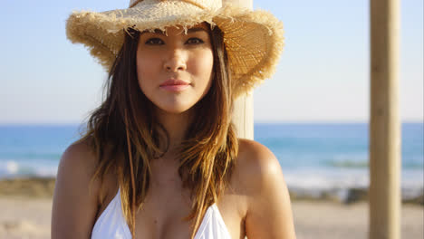 Beauty-in-white-swim-suit-stares-at-camera