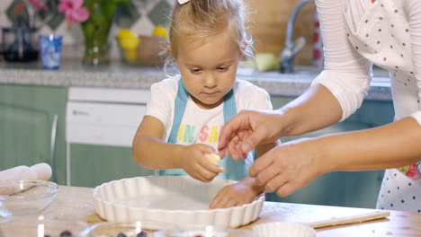 Cute-little-girl-greasing-a-baking-dish