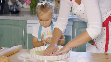 Mother-and-daughter-baking-a-homemade-pie