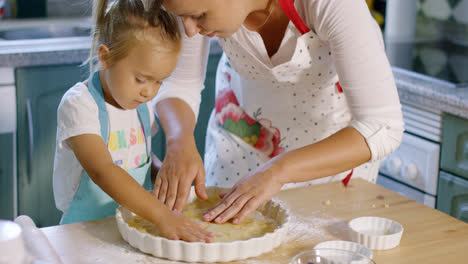 Mother-and-daughter-baking-a-homemade-pie