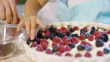 Little-girl-finishing-off-a-homemade-berry-pie