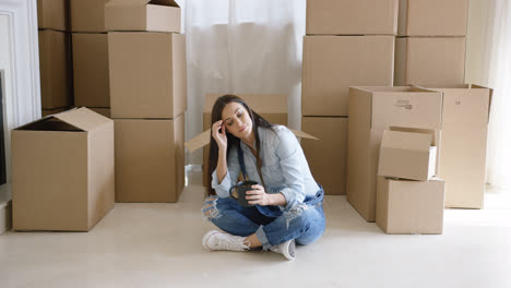 Tired-young-woman-taking-a-break-from-moving-house