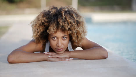 Mujer-Joven-Tomando-El-Sol-Cerca-De-La-Piscina