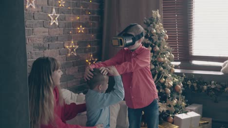 little-boy-in-virtual-reality-glasses-touches-brother-head