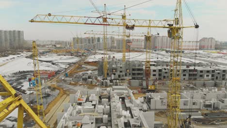 project-with-white-buildings-and-large-construction-cranes