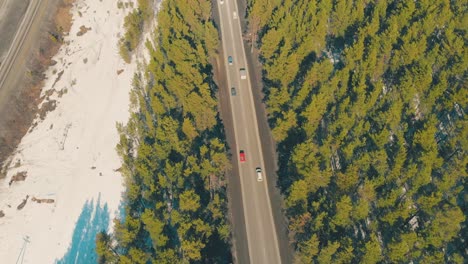 brown-lively-road-runs-along-wide-highway-aerial-view