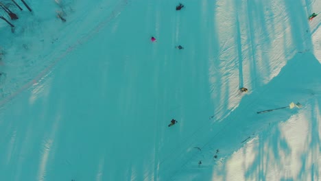 aerial-motion-over-people-sliding-on-ski-track-at-resort