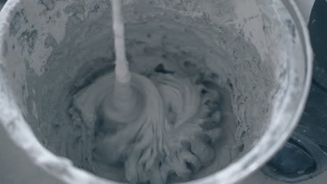 plastic-bucket-with-mixing-grey-putty-prepared-for-smearing