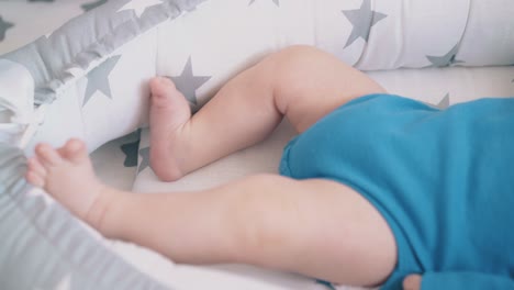 cute-child-bothers-legs-resting-in-sleeping-cocoon-closeup